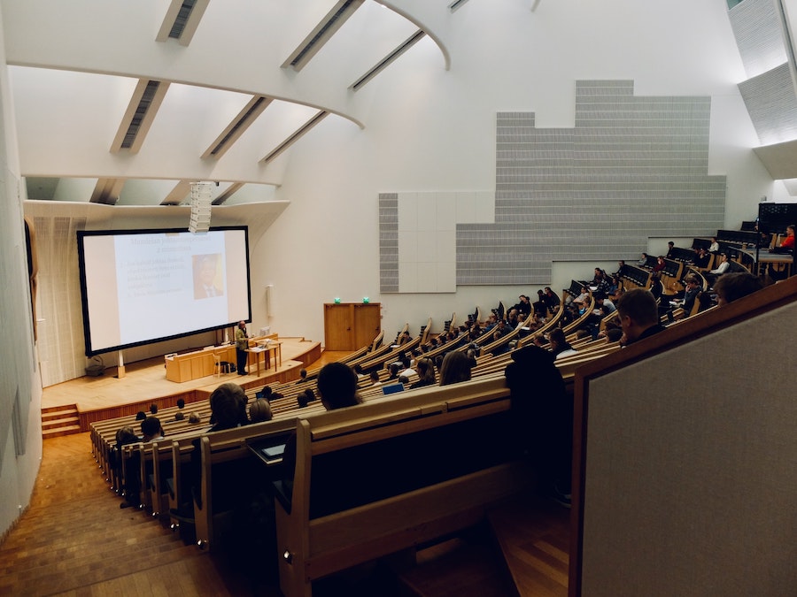 university lecture hall with audiovisual installation components like speakers, acoustical treatment, and a screen